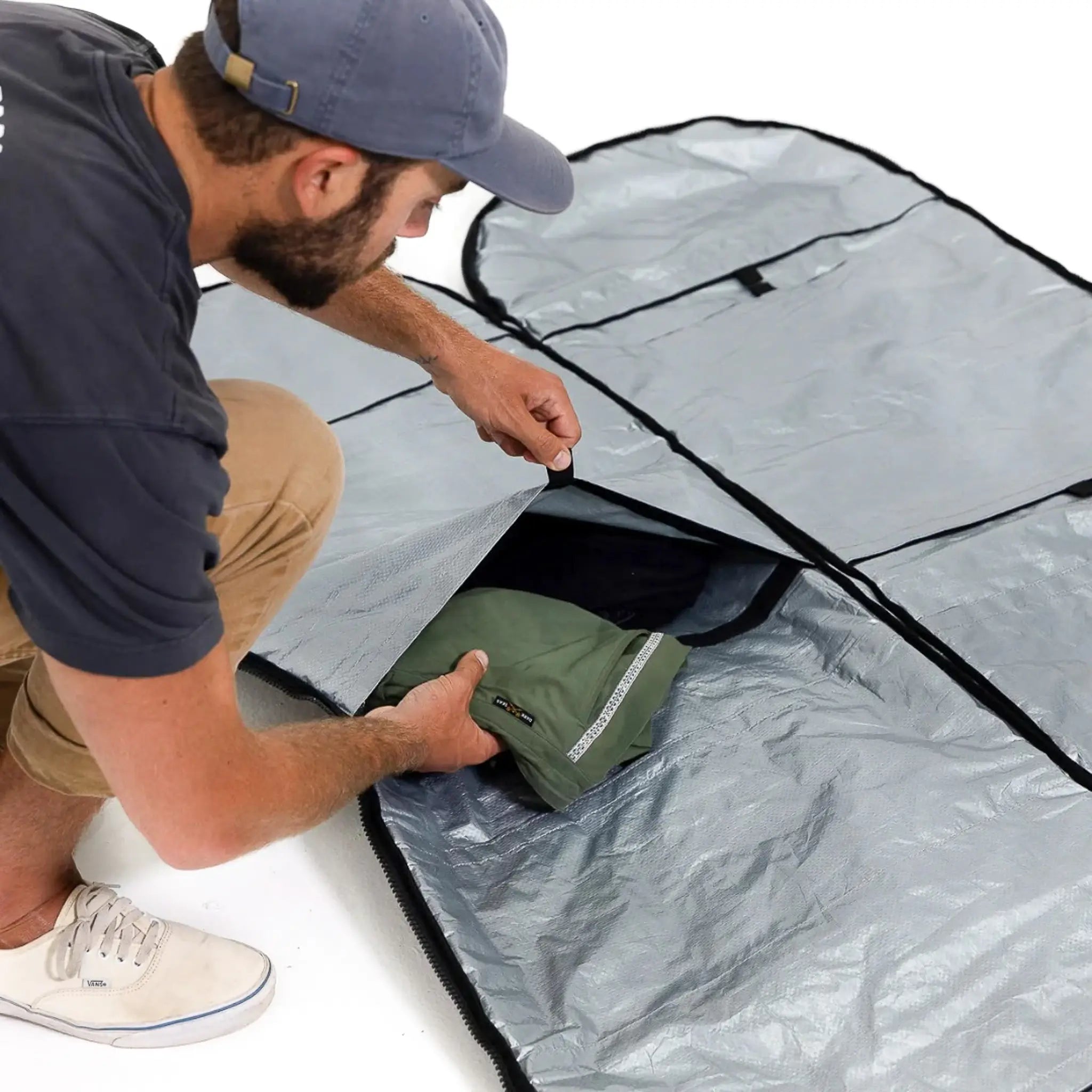 Man packing a surfboard bag